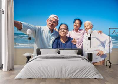 Group of asian seniors man and women happy time on the beach Wall mural