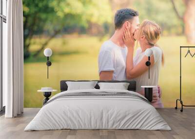 Portrait image of Young couple enjoying in the park at sunset. Concept romantic and love. Warm tone. Wall mural