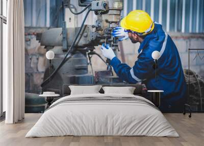 Portrait of Heavy industry workers working on the metal fabrication process by operating a lathe at a machine for steel structure industry. Wall mural