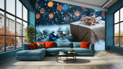 A gift sits on white snow with blue bokeh lights glowing softly. Fir branches with ornaments add holiday cheer as snow gently falls, creating a magical Christmas scene. Wall mural