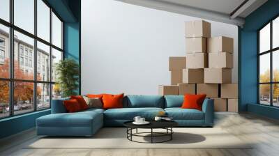 A group of cardboard boxes stacked in a corner of a plain white space, symbolizing organization, moving, and packaging solutions for home and business logistics Wall mural