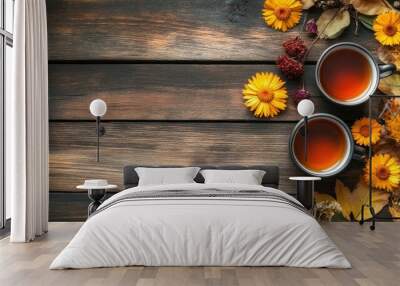 A rustic wooden table decorated with herbal tea cups and dried calendula flowers, with autumn leaves adding a seasonal touch, emphasizing the wellness benefits of herbal teas Wall mural