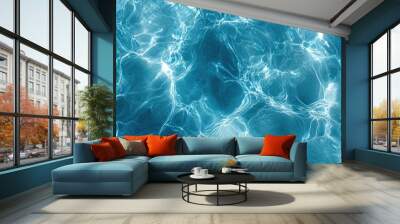 Close-up of transparent blue water with soft ripples and shining patterns, creating a peaceful and serene atmosphere. A perfect background texture. Wall mural