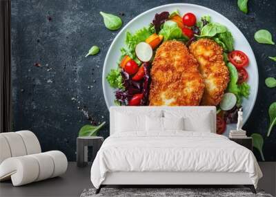 Crispy chicken schnitzel served with a fresh vegetable salad on a white plate over a dark background. Top view, showcasing a delicious and balanced meal Wall mural