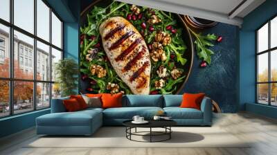 Flat lay of a grilled chicken breast fillet paired with a mixed salad of walnuts, pomegranate, and balsamic dressing on a dark background. A perfect healthy meal idea Wall mural