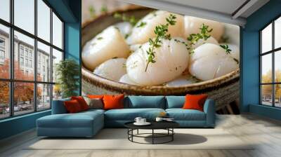 Fresh raw scallops in a rustic bowl with sprigs of thyme, set on a wooden table, showcasing their natural texture and freshness in a close-up view. Wall mural