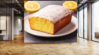 Freshly baked lemon loaf cake with sugar icing on a clean white plate, set on a stone surface with ample copy space. Wall mural