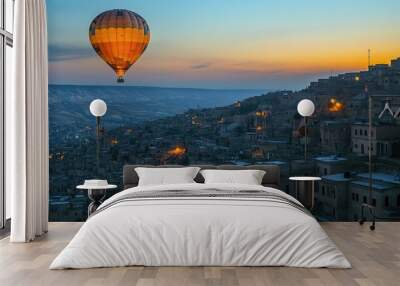 Hot air balloon flying over Mardin at twilight, with the blue hour light creating a beautiful contrast against the city's ancient stone buildings. Wall mural