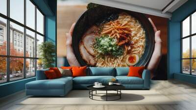 Top view of a ramen bowl with tonkotsu broth, ramen noodles, and a variety of toppings like chashu pork and nori. Wall mural