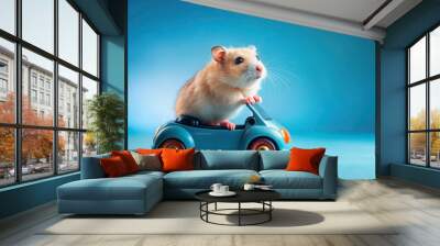 Adorable furry rodent rides miniature vehicle with wheels on bright blue background, showcasing joy and freedom in whimsical animal scene. Wall mural