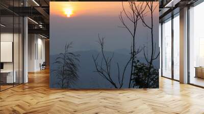 Soft focus beautiful sunrise and fog in the mountains at Phu Chi Fa of Chiang Rai, Thailand. Wall mural