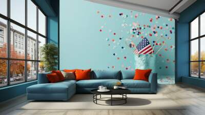 A blue glittery bag with an American flag inside, surrounded by colorful confetti against a blue background, creating a festive atmosphere. Wall mural