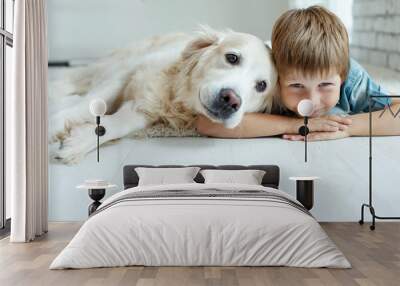 A child with a dog. Little boy with a dog at home.  Wall mural