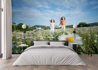 Beautiful children in the field with flowers.  Wall mural