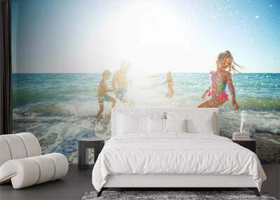 Children have fun on the sandy beach in summer. High quality photo. Wall mural