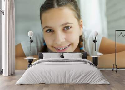 Close up portrait of smiling teenager girl showing dental braces.Isolated on white background. High quality photo. Wall mural