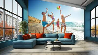 Cute kids having fun on the sandy beach in summer. High quality photo. Wall mural