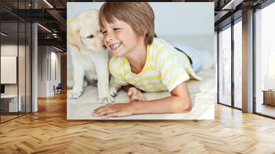 Happy kid with a dog at home  Wall mural