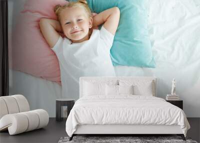 Little girl in bed with white linen. A child at home in the morning wakes up in his room. High quality photo. Wall mural