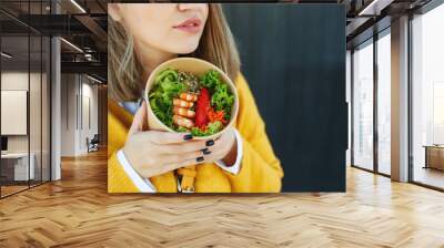 Portrait of a cheerful woman eating healthy salad. Concept of losing weight, sports and healthy eating. High quality photo. Wall mural