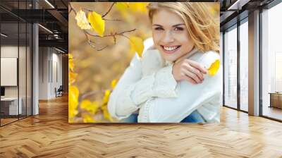 Portrait of beautiful young woman walking outdoors in autumn  Wall mural