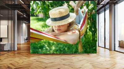 Summer vacation - lovely girl in a colorful hammock. High quality photo Wall mural