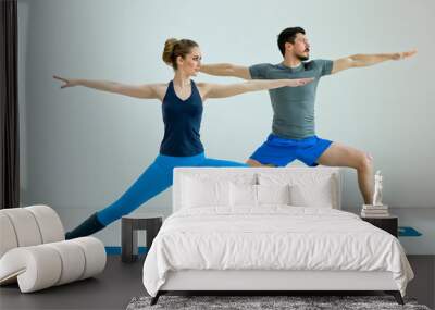 Two people making yoga in class Wall mural