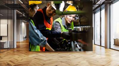 Asian Factory worker training to colleague on production line in Heavy Industry Manufacturing Facility. Instructor with Trainee working at factory. Wall mural