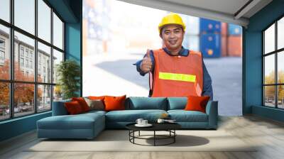 Asian man worker working and wearing safety hard hat helmet in the container yard. Foreman worker in safety suite at port of import and export goods. Wall mural