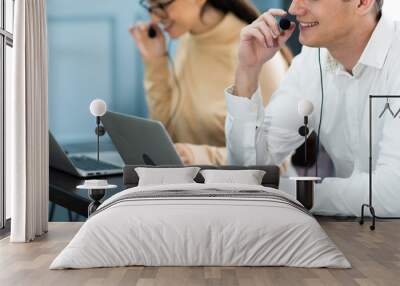 Beautiful female call center operator working on computer in office. Communication support for callcenter and customer service Helpdesk Wall mural