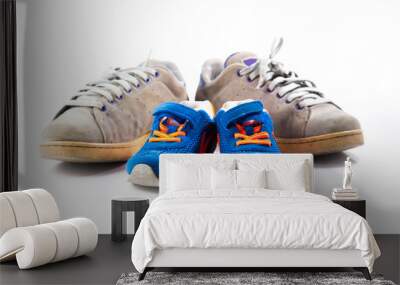 Big and small sneakers shoes on white background. Father's day composition Wall mural