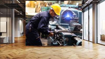 Factory Asian male worker. Asian man Lathe worker in production plant drilling at machine on the factory. Yellow hard hat safety first at mechanic factory. Wall mural