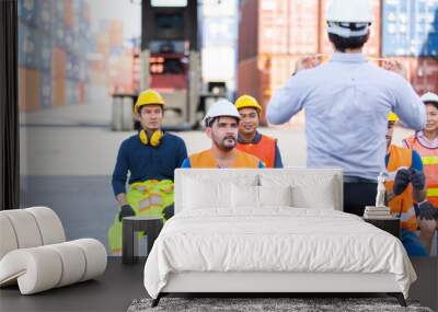 foreman is teaching and training workers how to wear face masks and take care of themselves while the coronavirus is spread. Wall mural