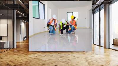 In doors. Professional Mechanical Engineer team wearing safety hard hat helmet working in  manufacturing factory under construction site. Wall mural