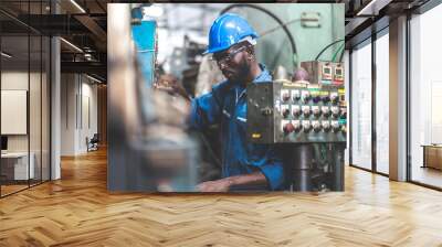 Male Engineer Working on laptop computer in Factory. black male engineer checking Quality control the condition of the machine. Service and maintenance of factory machinery Wall mural