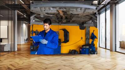 Portrait hispanic latin male mechanic repairs car in garage. Auto car mechanic professional working and checking car engine at garage. Car repair and maintenance Wall mural