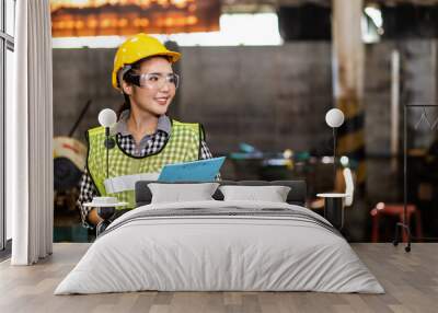 Portrait of beautiful Asian woman serious civil engineer wearing uniform and hardhats working at industrial factory. Engineering and architecture concept Wall mural