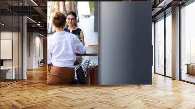 Portrait of carefree woman relaxing and drinking coffee with friend in cafe. Wall mural