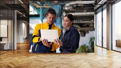 Portrait woman apprentice. Caucasian Female trainee Mechanics Working Underneath Car with male Instructor at Car maintenance and auto service garage. Car maintenance and auto service garage concept. Wall mural