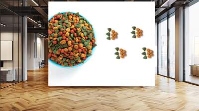 Top view Colourful Dried dog food in blue bowl on white background and Dog or cat paw print. Grain animal pet food banner background with copy space for text design. Wall mural