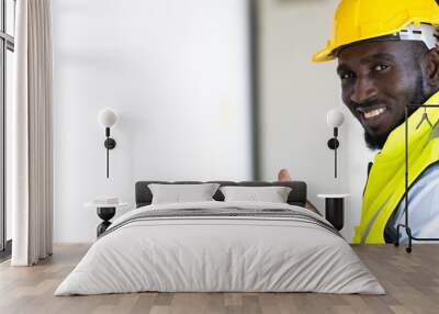 Warehouse man worker driver forklift. warehouse worker driver stacking card boxes by forklift in warehouse store. African American black people. Wall mural