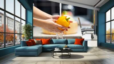 Wash vegetables - Close up woman hand. Fresh Vegetables washing in the kitchen. Clean food by water Wall mural