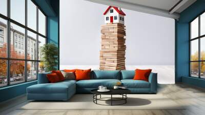 Modern house on wood tower block game white wall background copy space. Mortgage loan for buying home or real estate property, money risk management in financial, foreclosure and bankruptcy concept Wall mural