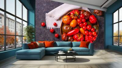 The harvest of assorted tomatoes. Colorful organic tomatoes on a large dish. Tomatoes different varieties. Top view Wall mural