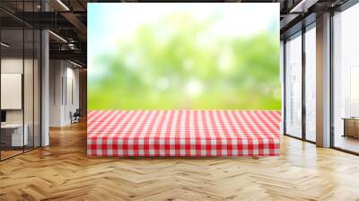 Checkered picnic red table cloth table on natural background. Wall mural