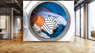 Washing machine drum with clothing close up. Textile washing.Laundry wash. Wall mural