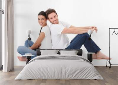 cheerful couple smiling happily on floor Wall mural