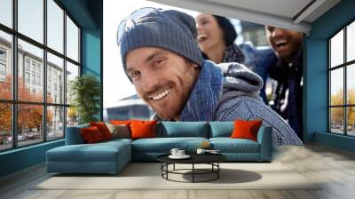 Happy young man in hat and scarf Wall mural