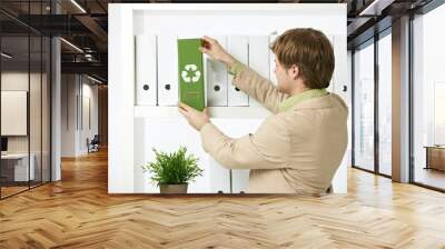 man drawing out green folder Wall mural