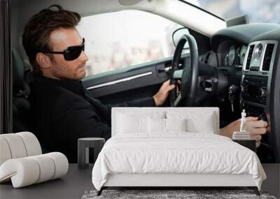 Man in black in luxury car Wall mural